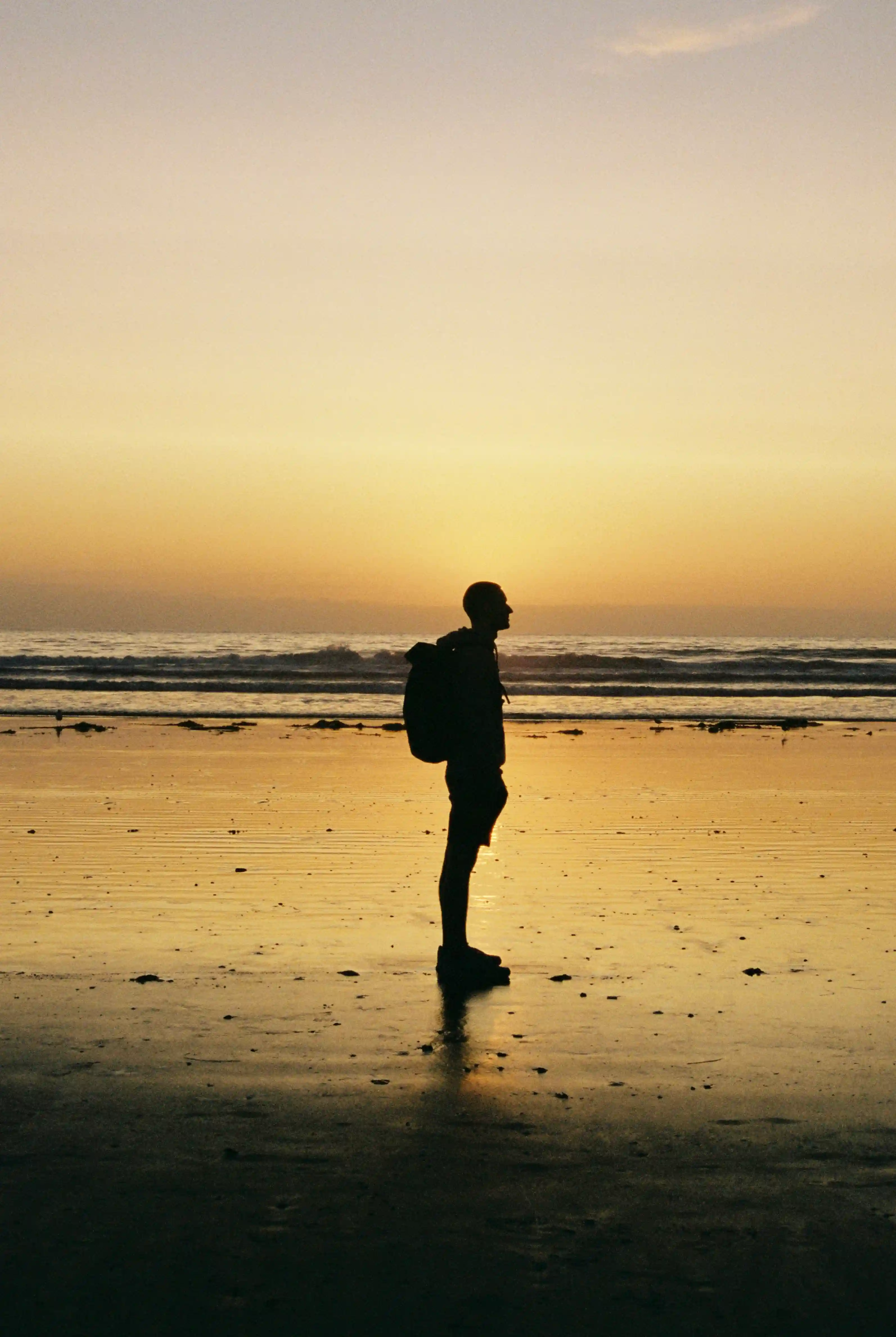 Shadows of person on beach during magic sunset