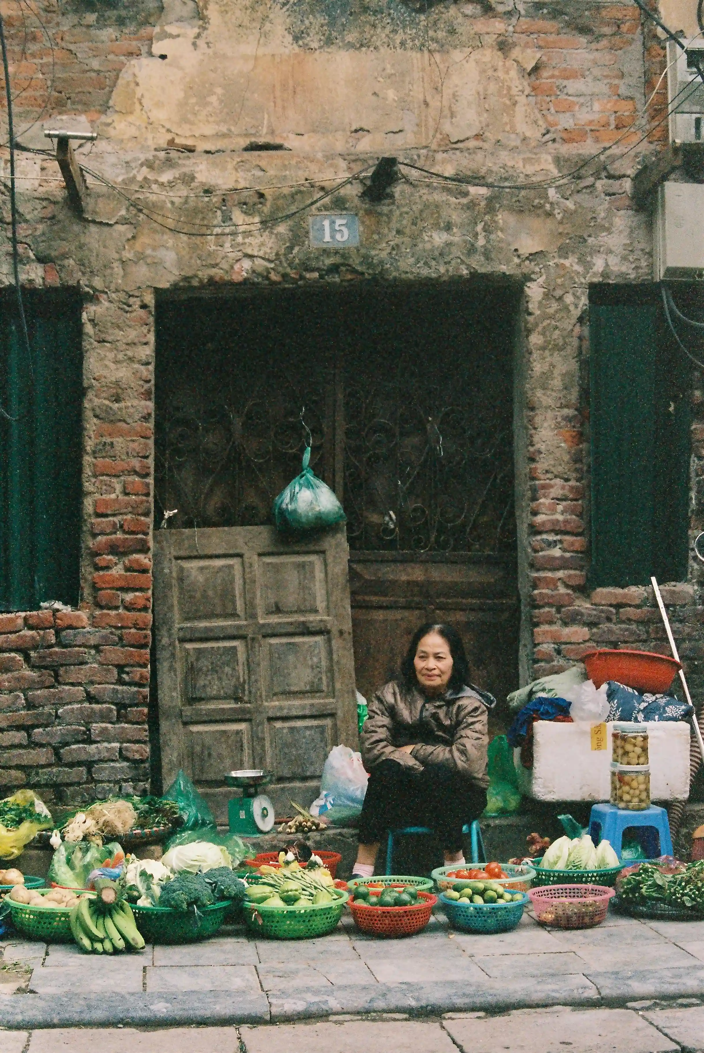 Old lady selling essential vegetables in vietnam